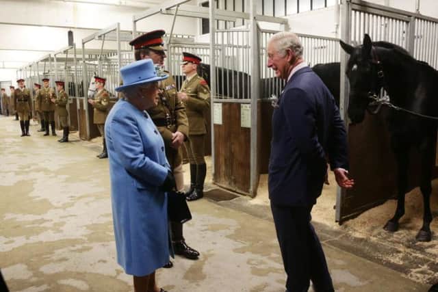 Queen Elizabeth II and the Prince of Wales visit the Household Cavalry Mounted Regiment at the Hyde Barracks, London