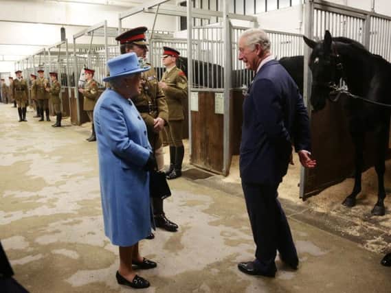 Queen Elizabeth II and the Prince of Wales visit the Household Cavalry Mounted Regiment at the Hyde Barracks, London