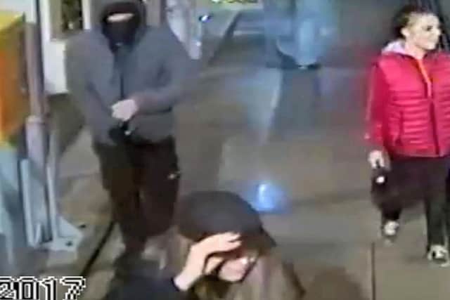 CCTV still taken from video issued by Greater Manchester Police of a man and two women on the platform at Didsbury Village Metrolink station in Manchester after another man was kicked off a tram platform on to the tracks.