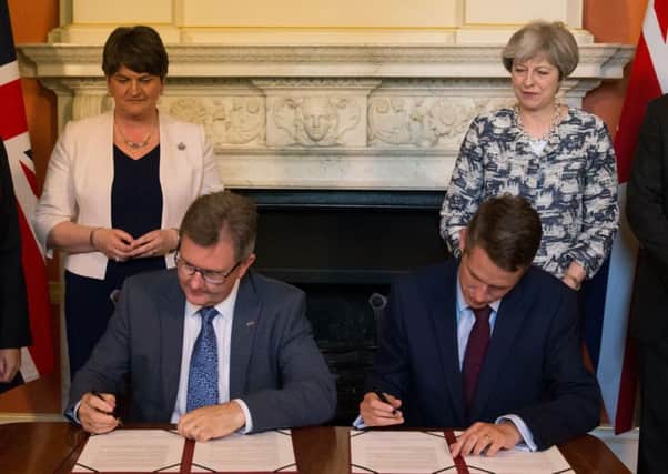 File photo dated 26/06/17 of Prime Minister Theresa May with DUP leader Arlene Foster (left), as DUP MP Sir Jeffrey Donaldson (second right) and Chief Whip Gavin Williamson sign paperwork inside 10 Downing Street, London, after the DUP agreed a deal to support the minority Conservative government. PRESS ASSOCIATION Photo. Issue date: Thursday October 26, 2017. A legal challenge against the controversial deal is to be launched at the High Court. See PA story COURTS DUP. Photo credit should read: Daniel Leal-Olivas/PA Wire