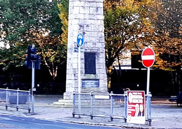 The Sinn Fein poster next to Omagh's cenotaph