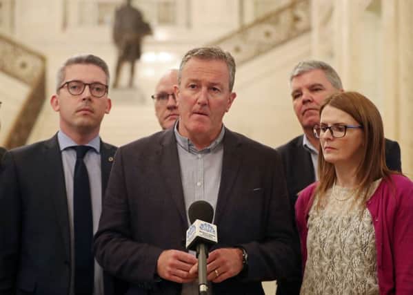Flanked by party colleagues, Sinn Feins Conor Murphy speaks to the media in Stormonts Great  Hall yesterday. Photo: Niall Carson/PA Wire