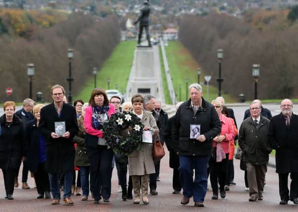 A group including family members of the missing men take part t in the 11th annual 'Silent Walk for the Disappeared' to remember victims of Northern Ireland's Troubles at Stormont, Belfast