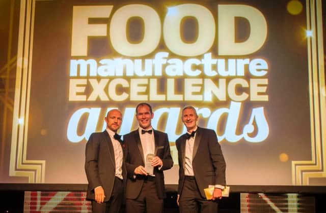 Colin Stanley of Willowbrook Foods, centre, collects the companys award from Jon Poole, chief executive of the Institute of Food Science & Technology, right, joined on stage by English rugby union star Matt Dawson
