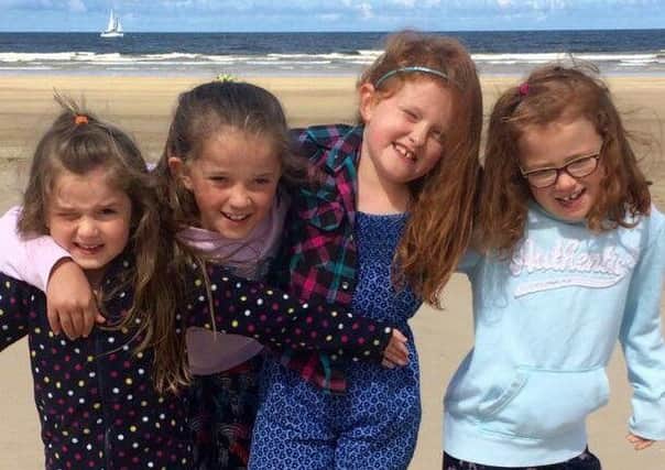 Isobel Anderson (second from left) having fun on the beach at Castlerock with her younger sisters Kate (left), Mary and Tess (right) in August this year.