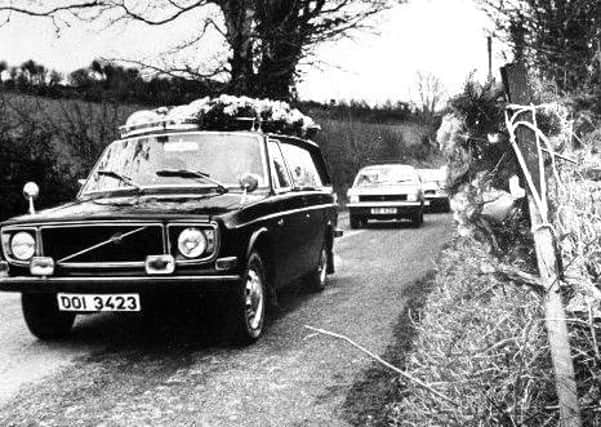 A funeral cortege of one of the Kingsmills victims passes the scene of the massacre in 1976