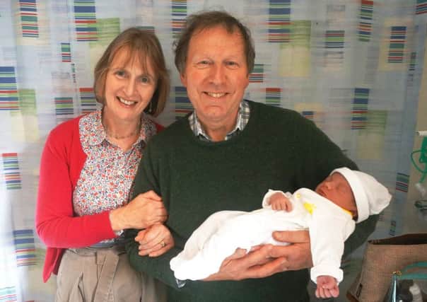 Rev John Mann with first grandchild Edward and wife Helen