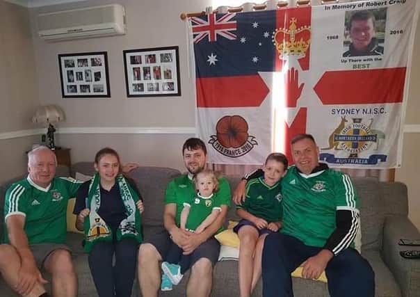 Supporters watching the game in Sydney with their children, from left David Martin, Mark Baxter and Andy Berryman, the club's honourary president.
