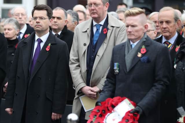 Secretary of State James Brokenshire (left) looks on as Stephen Gault, son of victim Samuel Gault, prepares to lay a wreath