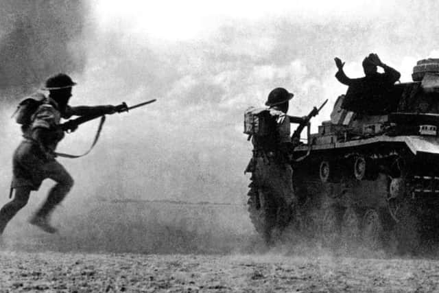 A German soldier in a tank surrenders to two soldiers belonging to the Commonwealth and Allied forces on Oct. 25, 1942, as a sandstorm clouds the battlefield at El Alamein.