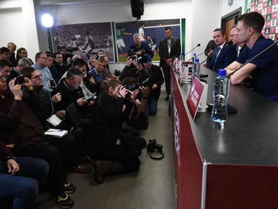 News Letter football commentator Patrick Van Dort, front left, takes the mood at the pre-match press conference.