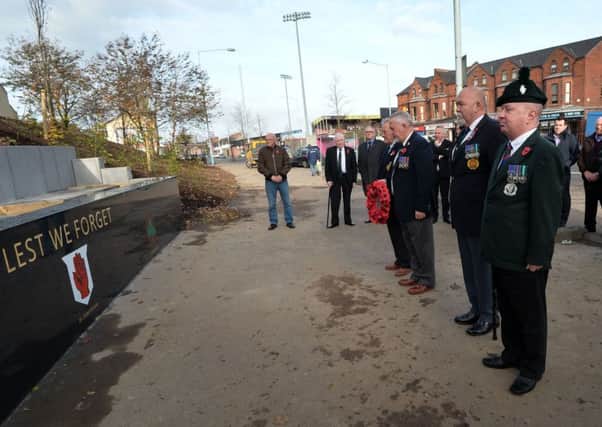 A wreath laying ceremony at the new memorial garden on the Shore Road