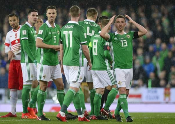 Corry Evans and his Northern Ireland team mates react in disbelief at the penalty decision awarded against them during the play-off game against Switzerland