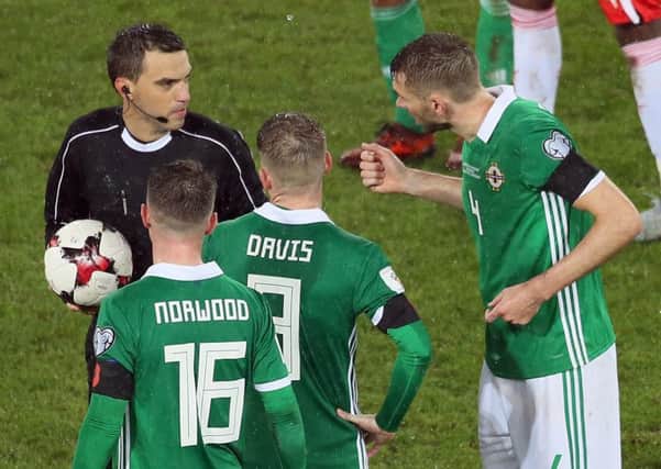 Referee Ovidiu Hategan dismisses protests by Northern Ireland's Oliver Norwood, Steve Davis and Gareth McAuley after his controversial penalty decision during the 1-0 defeat to Switzerland