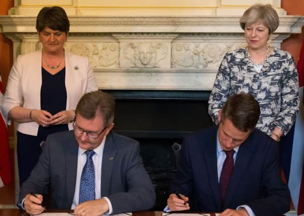 File photo dated 26/06/17 of Prime Minister Theresa May with DUP leader Arlene Foster (left), as DUP MP Sir Jeffrey Donaldson (second right) and Chief Whip Gavin Williamson sign paperwork inside 10 Downing Street, London, after the DUP agreed a deal to support the minority Conservative government. PRESS ASSOCIATION Photo. Issue date: Thursday October 26, 2017. A legal challenge against the controversial deal is to be launched at the High Court. See PA story COURTS DUP. Photo credit should read: Daniel Leal-Olivas/PA Wire