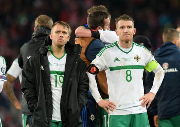 Dejected Northern Ireland players Jamie Ward and Steve Davis  after the game against Switzerland on Sunday at the St Jakob-Park Stadium, Base in which their World Cup hopes were dashed. Photo Colm Lenaghan/Pacemaker Press