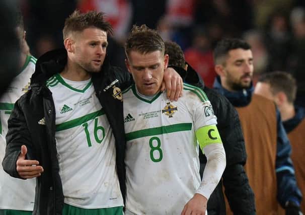 Northern Ireland's Oliver Norwood and Steve Davis  dejected after the game in Switzerland