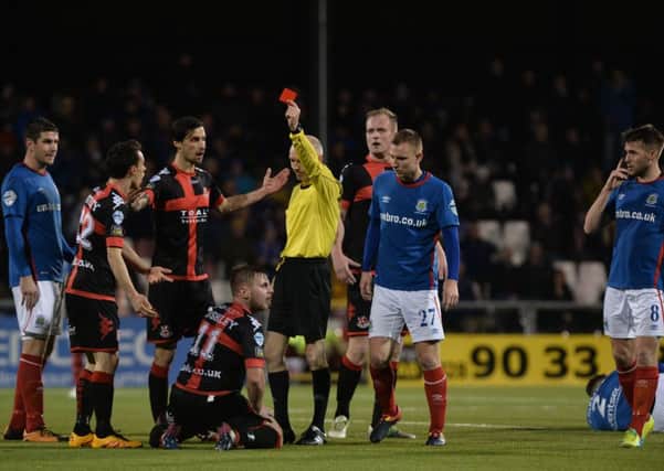 Referee Raymond Hetherington reverses a red card for Crusaders' David Cushley and gives the red card instead to Linfields Mark Stafford. Pic by Pacemaker.