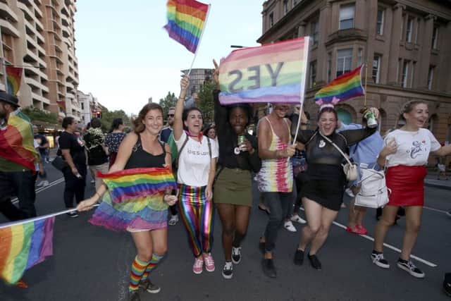 Members of the gay community and their supporters celebrate the result of a postal survey calling for gay marriage right in Sydney, Australia, Wednesday, November 15, 2017. Australians supported gay marriage in a postal survey that ensures Parliament will consider legalizing same-sex weddings this year. (AP Photo/Rick Rycroft)