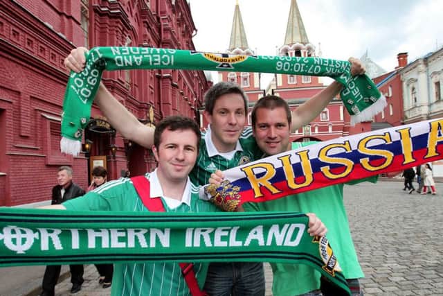 Owen Polley, centre, in Russia for an earlier Northern Ireland game, with fellow Northern Ireland fans Richard Oliver and Gordon McKeown, from Ballymena, pictured in Moscow's Red Square, during a 2012 World Cup qualifier. Picture Press Eye