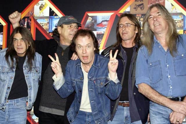 Malcolm Young (left) was a guitarist in rock band AC/DC