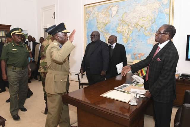 Zimbabwean President, Robert Mugabe, right, meets with Defence Forces Generals at State House, in Harare, on Sunday, the day that members of the ZANU PF Central committee fired Mugabe as party chief and replaced him with dismissed deputy President, Emmerson Mnangagwa on Sunday. (AP Photo)