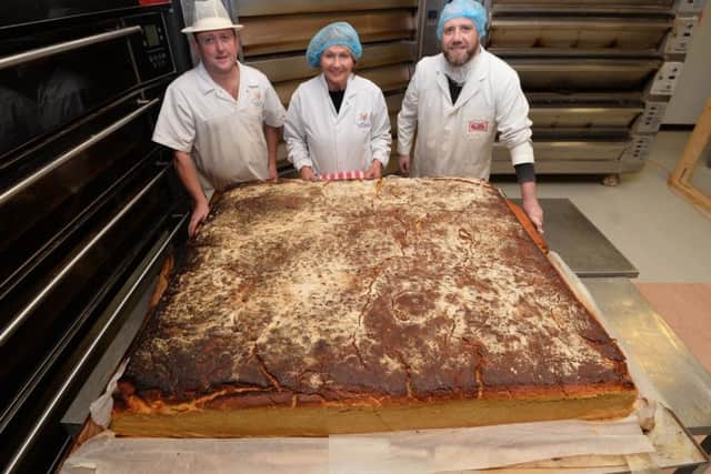 From L-R Warren Patton (Patton's Bakery), Jenny Bristow and Karl McCrum (Neill's Flour) with what could be the world's largest scone.

 
Pic Colm Lenaghan/Pacemaker