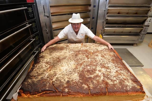Warren Patton gets to grips with the world's largest scone.

Pic Colm Lenaghan/Pacemaker