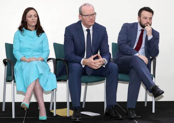 Simon Coveney TD, centre, with SDLP deputy leader Nicola Mallon, left, and SDLP leader Colm Eastwood, at a business breakfast in Belfast yesterday. Photo: Declan Roughan/Press Eye/PA Wire