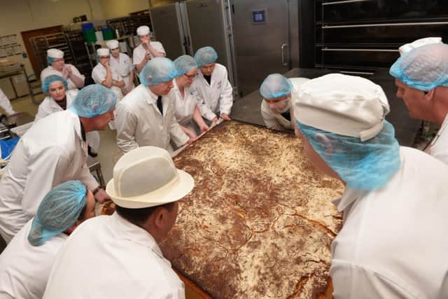 The giant scone emerges from the oven. 

Pic Colm Lenaghan/Pacemaker