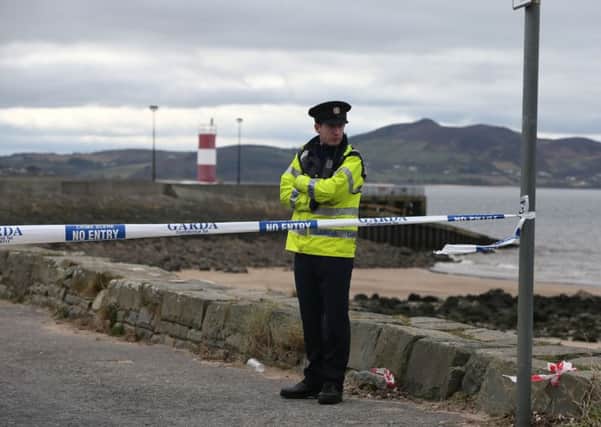 File photo dated 21/03/16 of a policeman at the scene at Buncrana Pier in Co Donegal after five people were killed when a car they were in slipped from a pier, as an inquest is to begin later