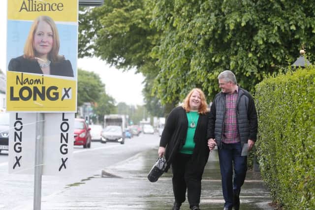 The 
Alliance Party leader Naomi Long and her husband Michael, a councillor in Belfast, under a poster for the party in east Belfast, a stronghold for Alliance. 

Picture by Jonathan Porter/PressEye.com